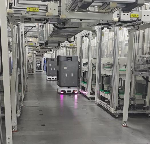 AGV transporting loads through a production or warehouse aisle